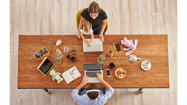 Couple working from home with them child, wooden table, laptop toy and lamp, up concept.